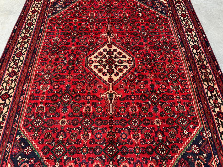 Handgemaakt Perzisch wollen vloerkleed 7x10 - Rood Perzisch tapijt met geometrisch medaillon en ivoorkleurige rand - Exacte afmeting 9'10" x 6'8" - KBHM-843