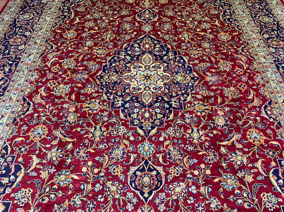 9'6" × 13'10" Handgeknoopt Perzisch wollen tapijt – Rood veld met marineblauwe & ivoorkleurige bloemenrand