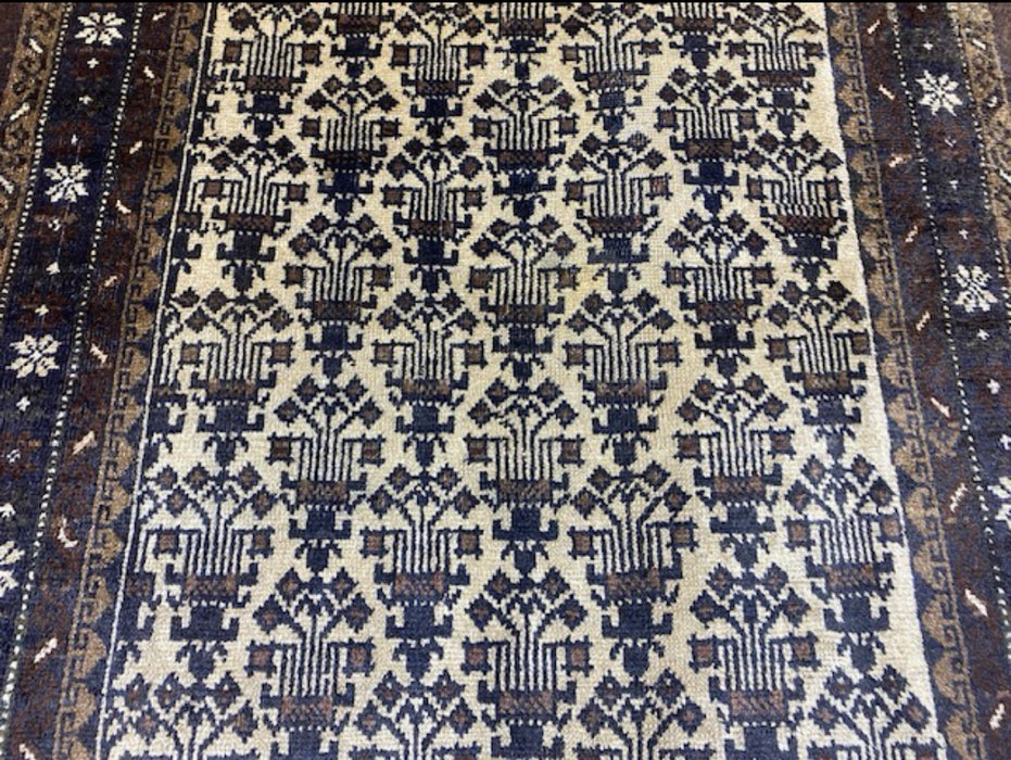 100 × 175 cm handgeknoopt Baluch wollen tapijt – Ivoor & Indigo geometrisch motief